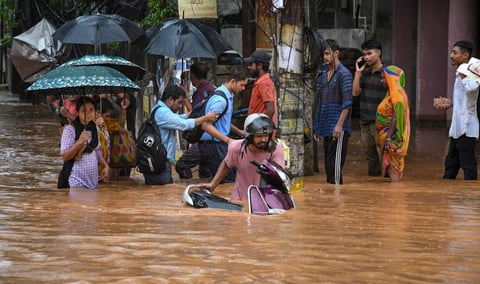 Guwahati: People wade through a flooded road after monsoon rainfall, in Guwahati, Monday, Aug. 5, 2024